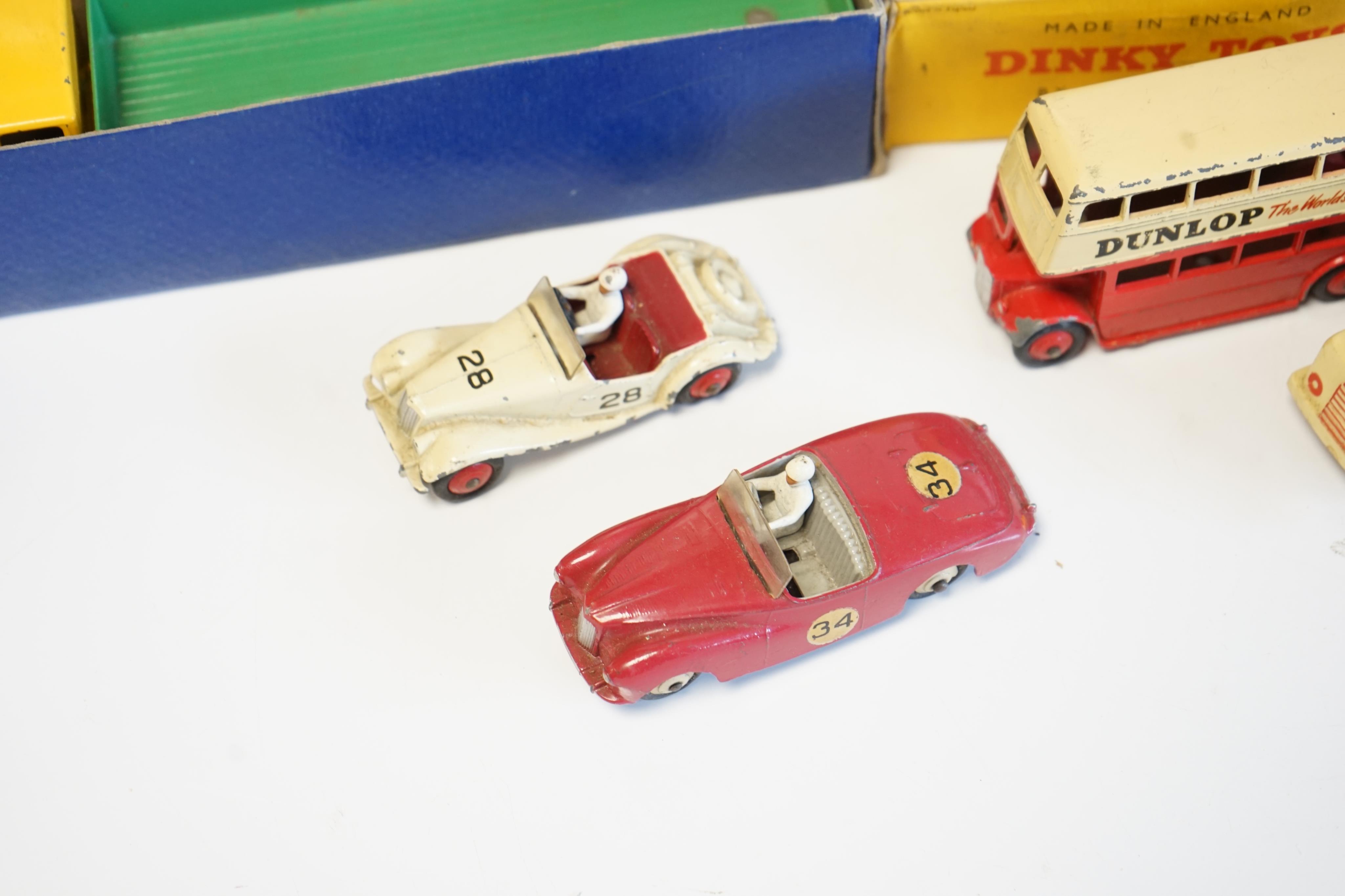 Seven diecast vehicles by Dinky Toys and Corgi Toys including; a Leyland Octopus Wagon (934), a Caravan (190), a Sunbeam Alpine, an MG Midget, a Double Decker bus, a Euclid TC-12 Tractor (1102), an ERF Model 64G Earth Du